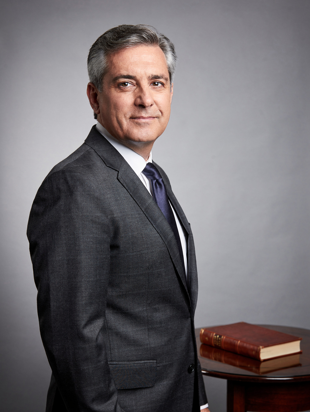 Arthur Sterling, Senior Partner at VESTA, reviewing legal documents